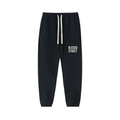 Black jogger sweatpants with a white drawstring and 'BLESSED STREET' printed in white on the left thigh, shown against a plain white background.