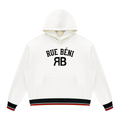 An off-white pullover hoodie with 'RUE BÉNI' and 'RB' printed in black on the chest, featuring black and red striped ribbed cuffs and hem.